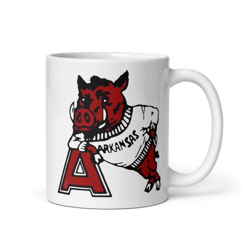 Cream ceramic mug featuring Arkansas '55 Booster Club Razorbacks design; available in 11 and 15 oz sizes.