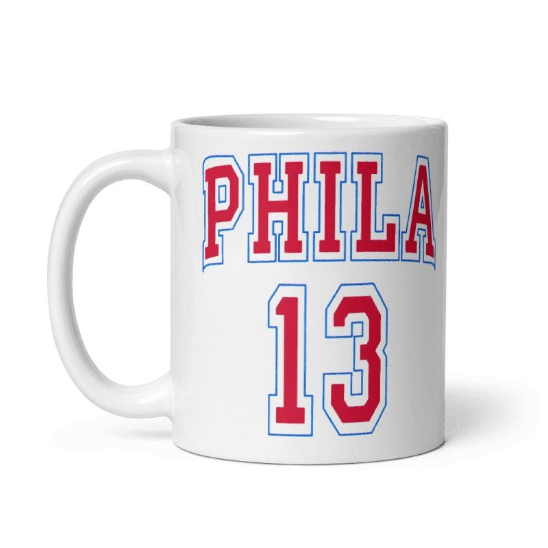 White ceramic mug with red and blue "PHILA 13" design inspired by 66-67 Wilt Chamberlain 76ers jersey