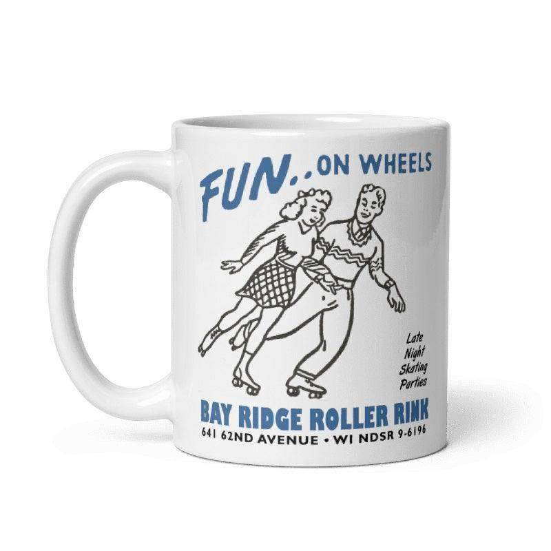 Cream ceramic mug featuring vintage Bay Ridge Roller Rink design with skaters, available in 11oz and 15oz sizes.