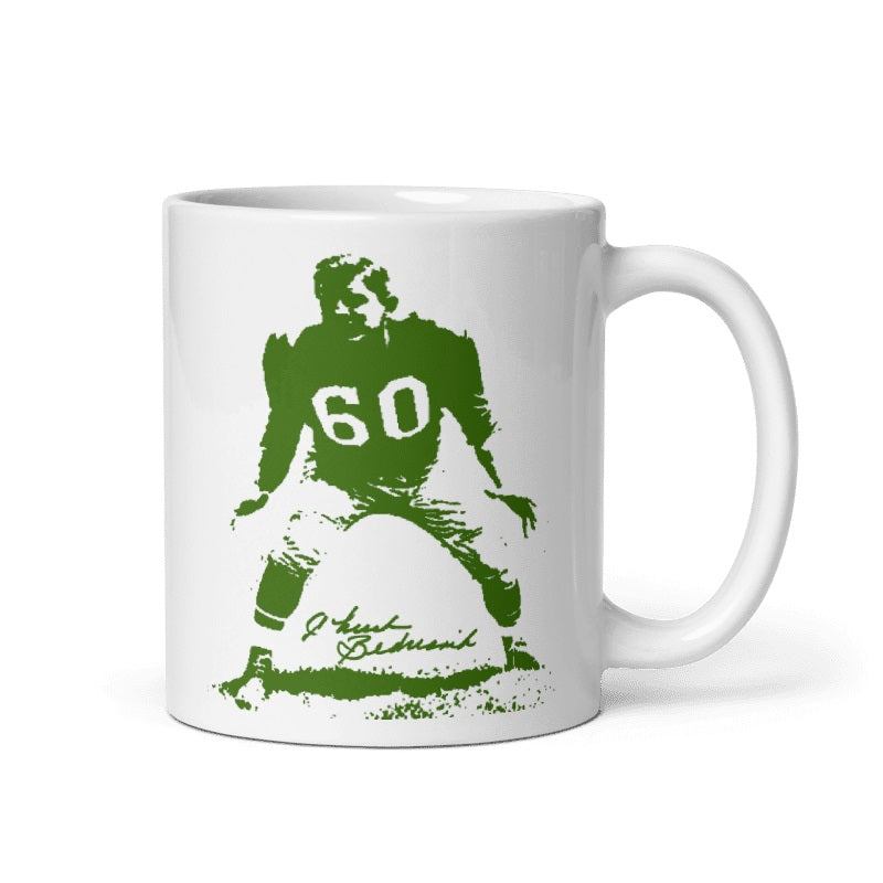 Cream-colored ceramic mug featuring Chuck Bednarik illustration, available in 11oz and 15oz, microwave and