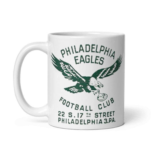 Vintage Philadelphia Eagles ceramic mug with 1940s graphic, cream color.