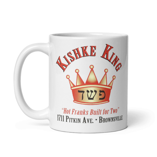 Brooklyn Kishke King ceramic mug with crown design, cream color, available in 11oz and 15oz, microwave and dishwasher safe.