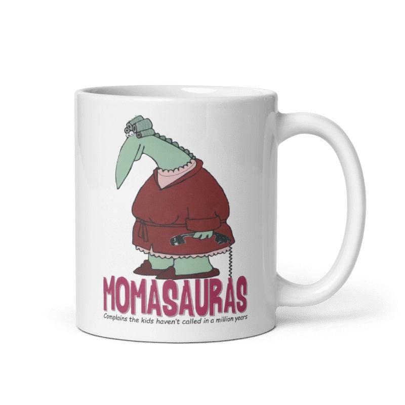 Cream-colored ceramic Momasauras Mug with dinosaur illustration, available in 11oz and 15oz, microwave and dishwasher safe.